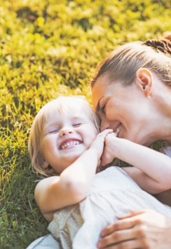 Mother and child playing on grass